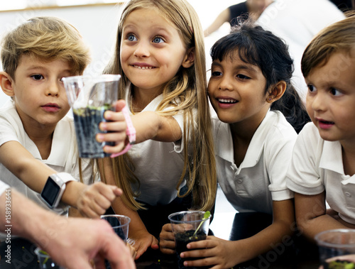 Slika na platnu Group of diverse kindergarten students learning planting experiment in science l
