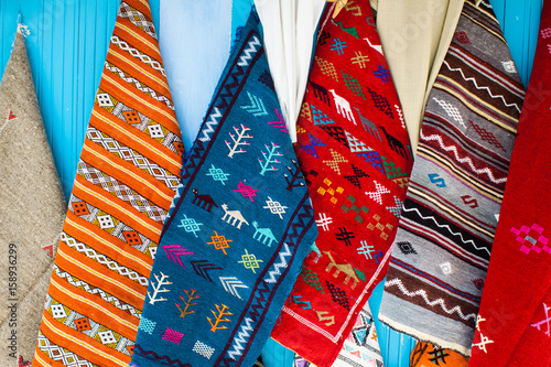 full frame shot of colorful moroccan carpets pending on a wall in a craft market
