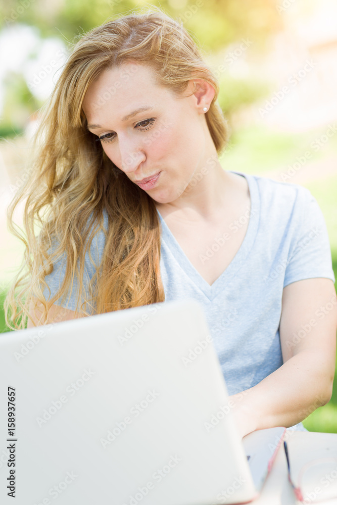 Young Adult Woman Live Video Chatting Outdoors Using Her Laptop. Young Adult Woman Live Video Chatting Outdoors Using Her Laptop.