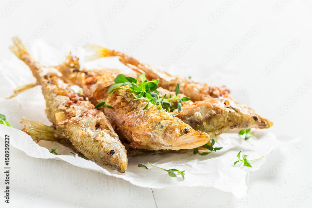 Tasty roasted smelt fish on white background Tasty roasted smelt fish on white background