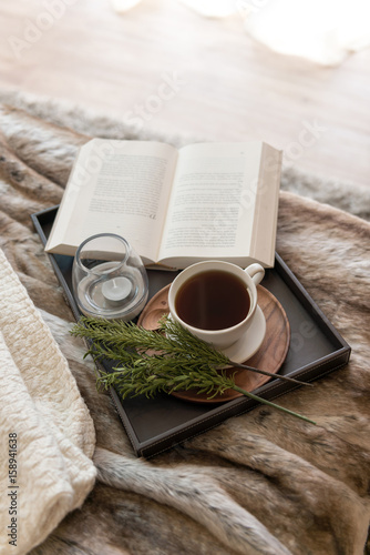 Coffee and book on the bed with window light in the morning 