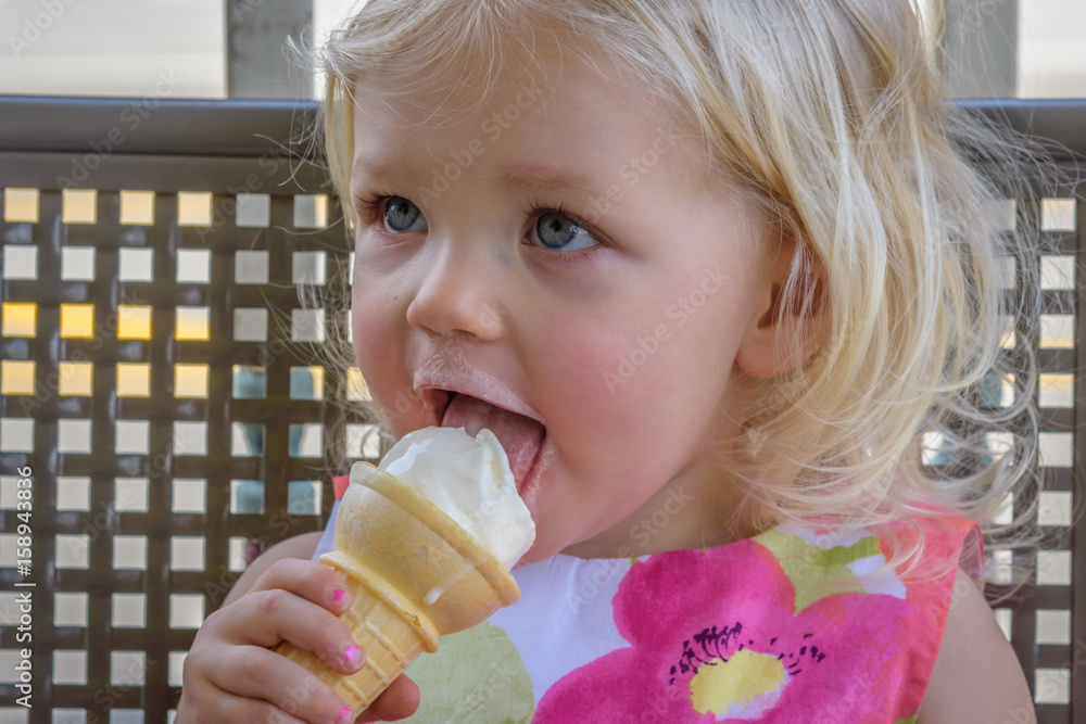 Little girl licking ice cream cone Stock Photo Adobe Stock