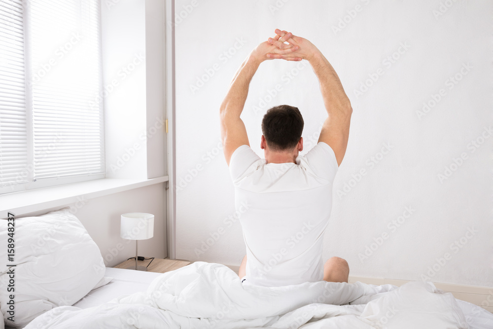 Man Stretch His Hand After Wake Up In Bed Man Stretch His Hand After Wake Up In Bed