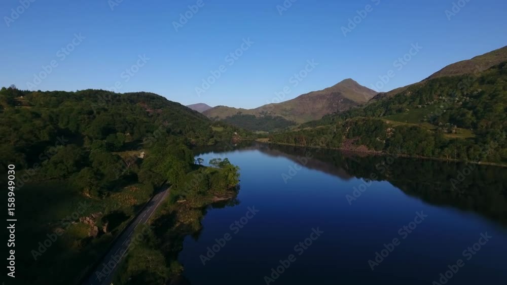 Rising aerial view of a lake in Snowdonia, UK. Rising aerial view of a lake in Snowdonia, UK.