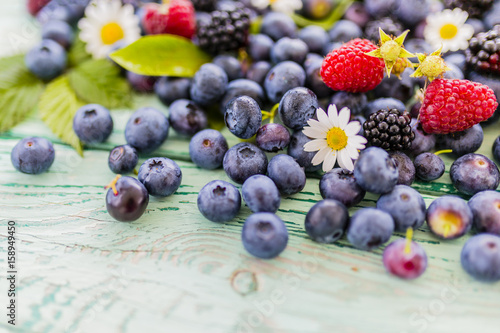 Tablou pe pânză Fresh berries from garden on wooden background.