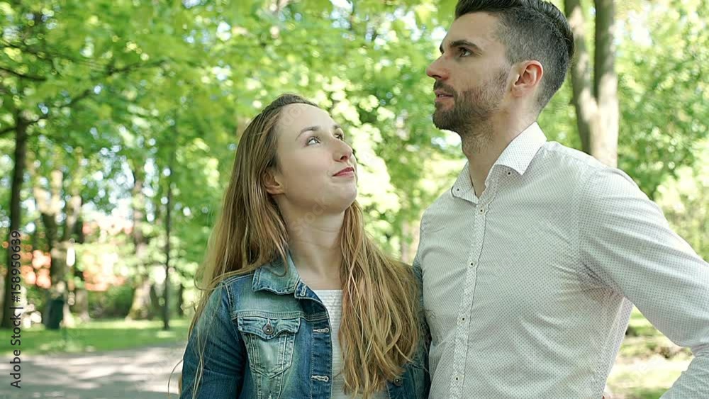 Happy couple standing in the park and chatting with each other, steadycam shot
Happy couple standing in the park and chatting with each other, steadycam shot