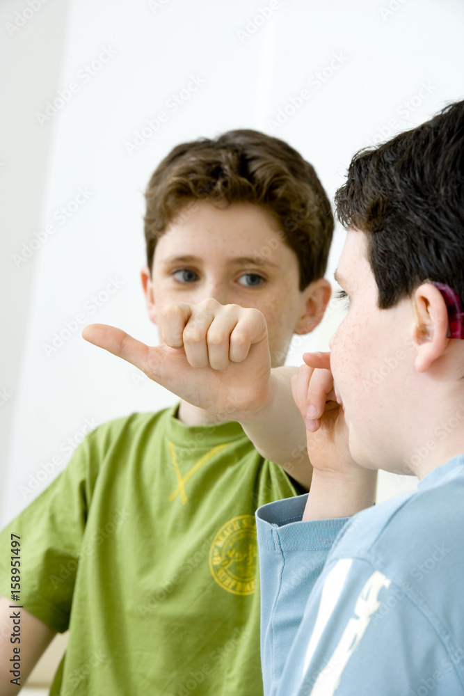 Models Do not use for HIV Young boy using the French sign language to discuss with his hearing-impaired brother The French sign language uses signs to designate words but also dactylology (each letter of the alphabet is represented by a defined position of the fingers then enabling to spell a word) and the lip reading The young boy designates the letter \a\ (see image nᄚ0833202 ans series of images from nᄚ0572308 to 0574108 to see the other letters of the alphabet) Models Do not use for HIV Young boy using the French sign language to discuss with his hearing-impaired brother The French sign language uses signs to designate words but also dactylology (each letter of the alphabet is represented by a defined position of the fingers then enabling to spell a word) and the lip reading The young boy designates the letter \a\ (see image nᄚ0833202 ans series of images from nᄚ0572308 to 0574108 to see the other letters of the alphabet)