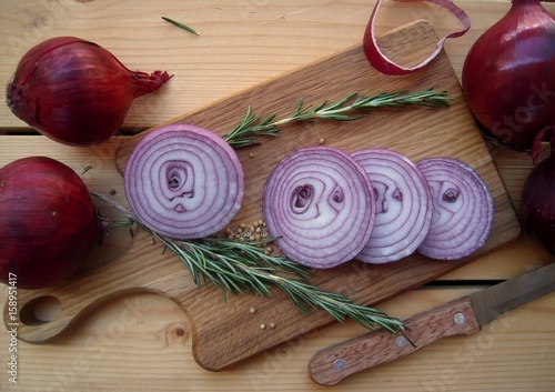 Red onion sliced on a cutting board........