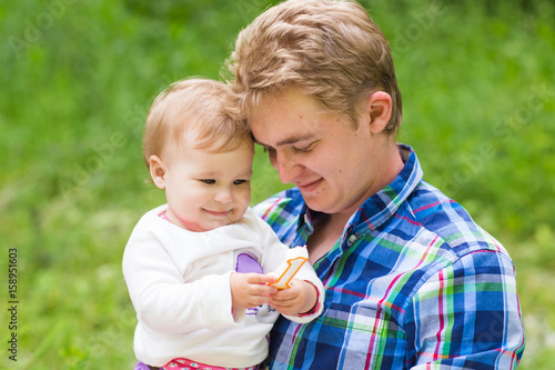 father and baby daughter playing in the park