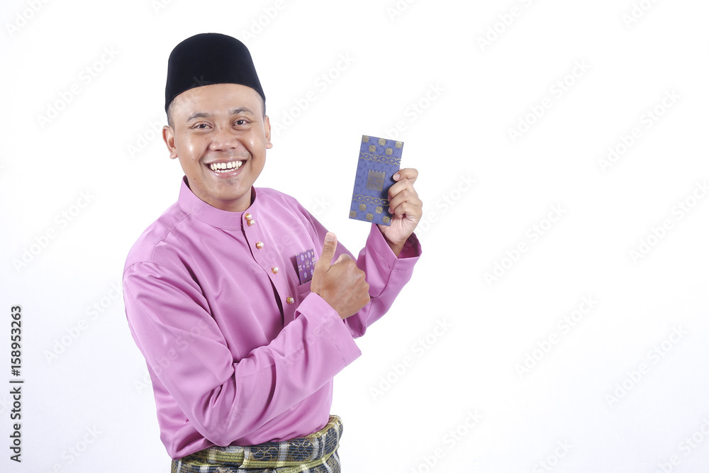 Man in traditional clothing cheerful with money packet during celebrate Eid Fitr. Man in traditional clothing cheerful with money packet during celebrate Eid Fitr.