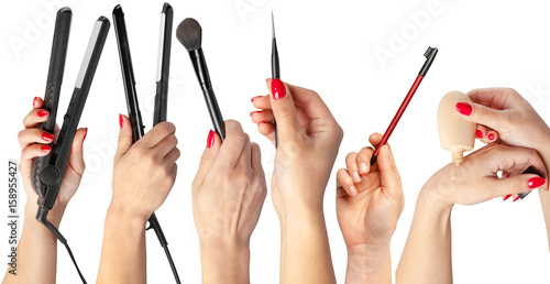 collection of hands holding tools for makeup isolated on white