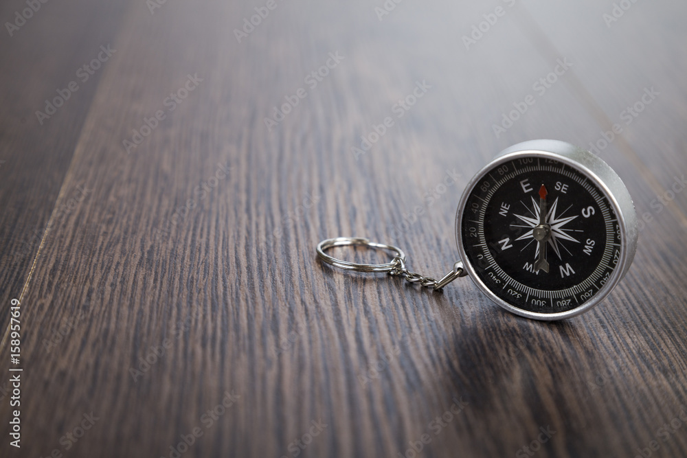 Compass on a wooden table Compass on a wooden table