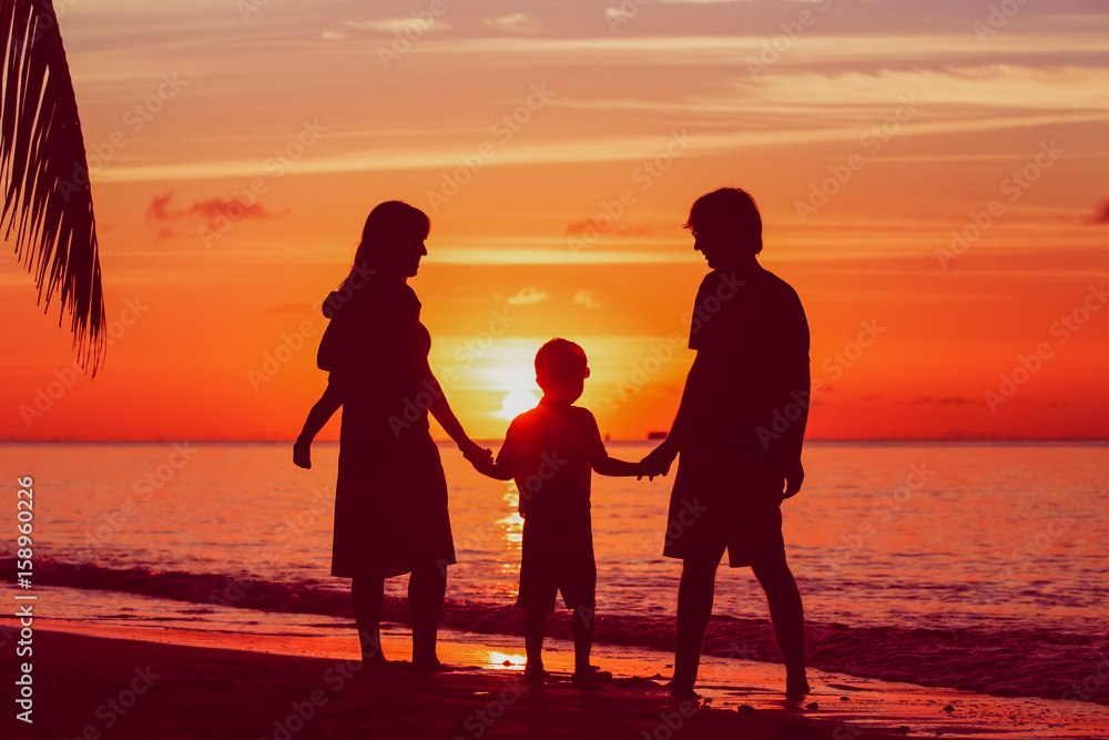 happy family with two kids on sunset beach