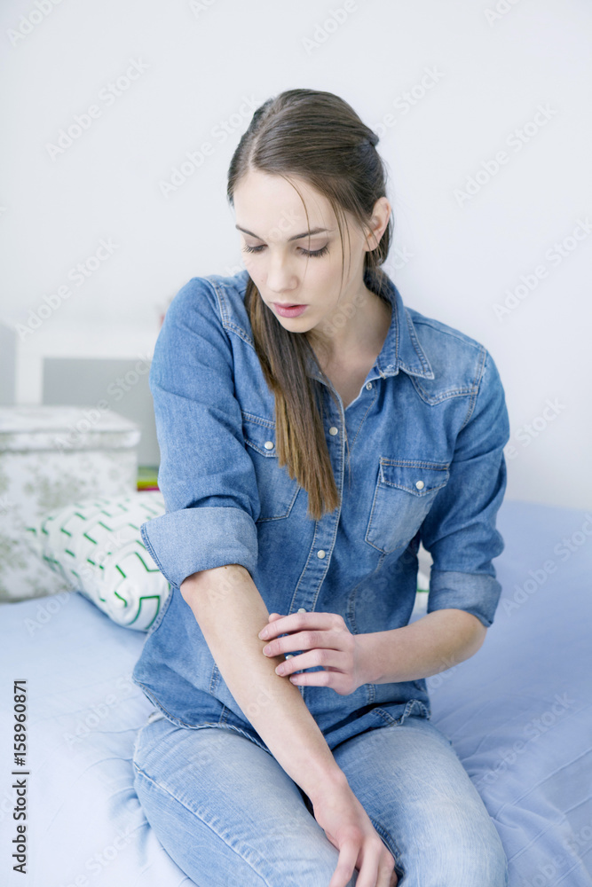 Fototapeta premium Woman scratching her arm
