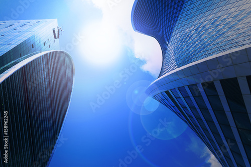 glass facade of the business center with solar light in the sky