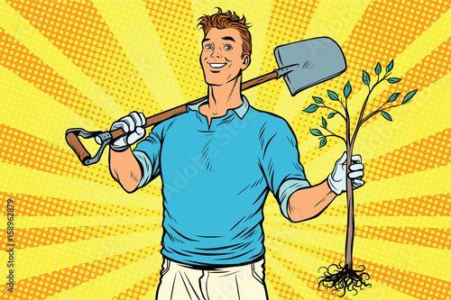 Man gardener with a shovel and sapling
