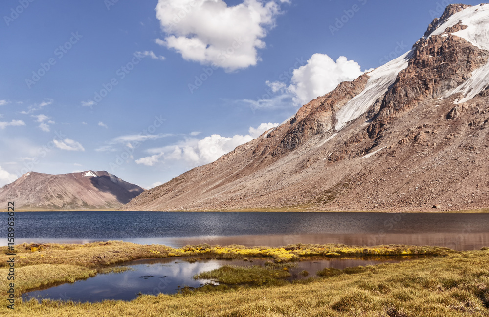 Obraz premium Landscape of mountains and glaciers in the sunny weather. mountain river, lake.