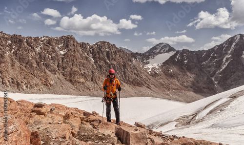 climber on a glacier with equipment with a rope in the mountains