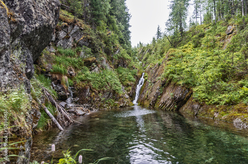 Mountain lake, waterfall, around the forest, rocks, mountain landscape. Ural mountains.