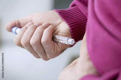Man injecting himself with insulin