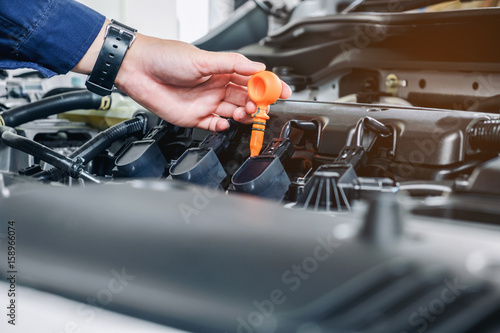 Mechanic changing oil mechanic in auto repair service. © joyfotoliakid