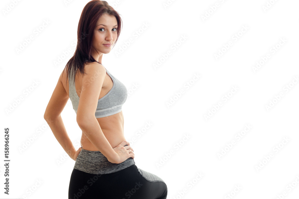horizontal portrait of young sports Brunettes at the top which looks into the camera and keeps hands on the sides horizontal portrait of young sports Brunettes at the top which looks into the camera and keeps hands on the sides