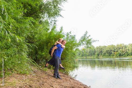 Young couple having fun at the beach of the lake on a sunny day © satura_