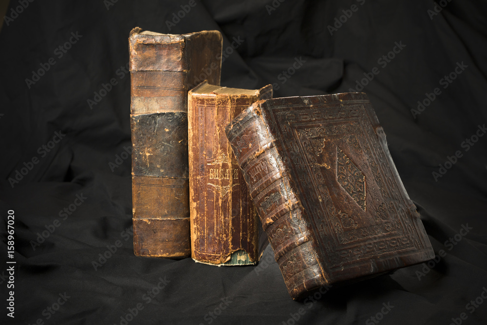 Old book spines on black background. Ancient library. Antique Holy  Scripture books. Antique books collection. Wisdom knowledge in old books.  Torn hard cover books spine sides. Stock Photo | Adobe Stock