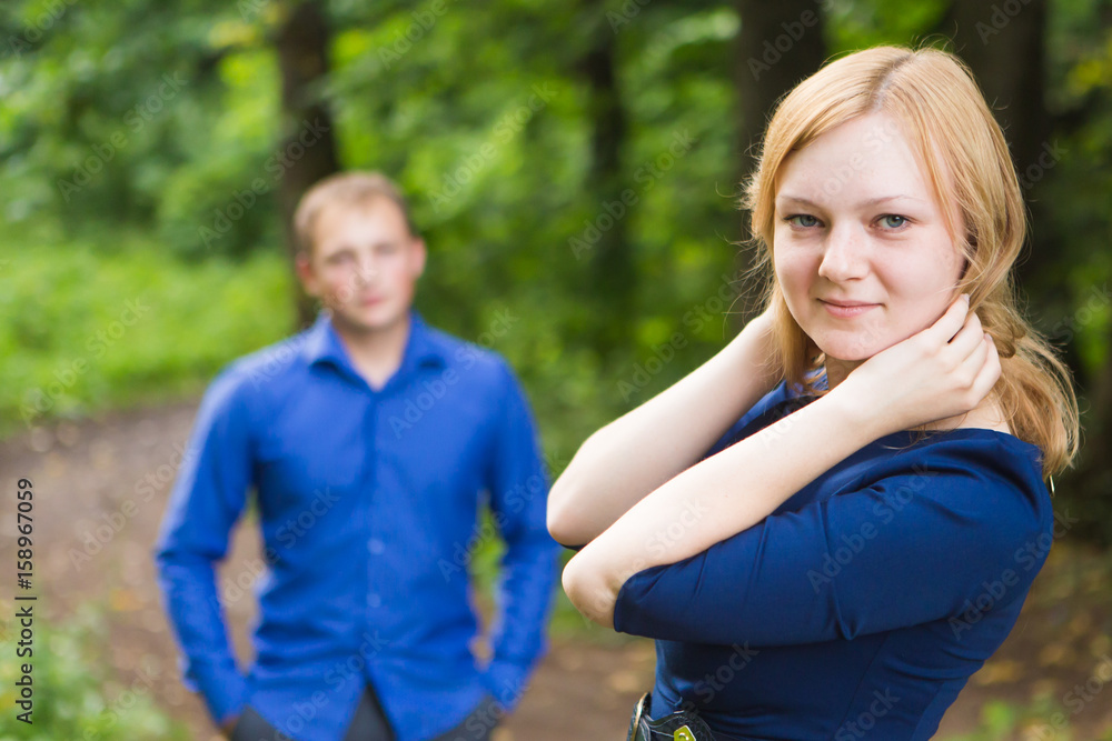 portrait beautiful young couple man woman quarreled background summer green park. portrait beautiful young couple man woman quarreled background summer green park.
