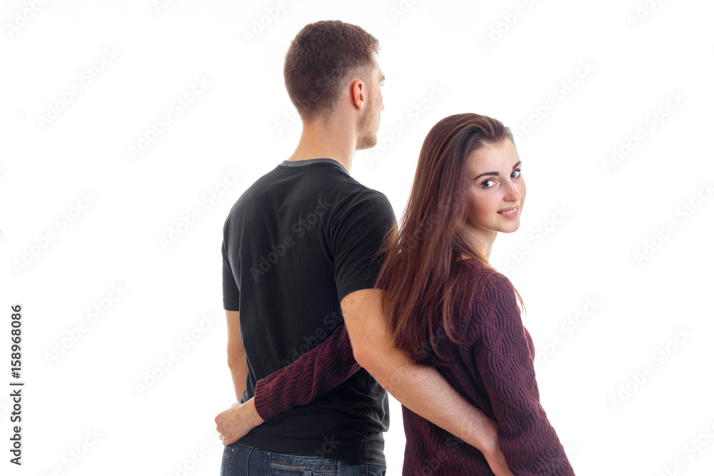 Cute young couple hugging and smiling in studio Cute young couple hugging and smiling in studio