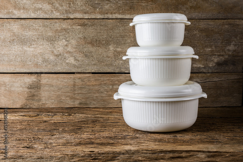 Empty containers for food on wooden background