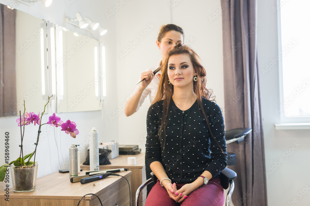 Hairdresser doing haircut for women in hairdressing salon. Concept of fashion and beauty. Positive emotion. Hairdresser doing haircut for women in hairdressing salon. Concept of fashion and beauty. Positive emotion.