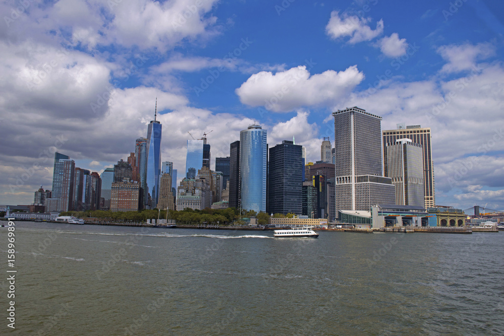 New York City lower Manhattan financial wall street district buildings skyline on a beautiful summer day with blue sky
