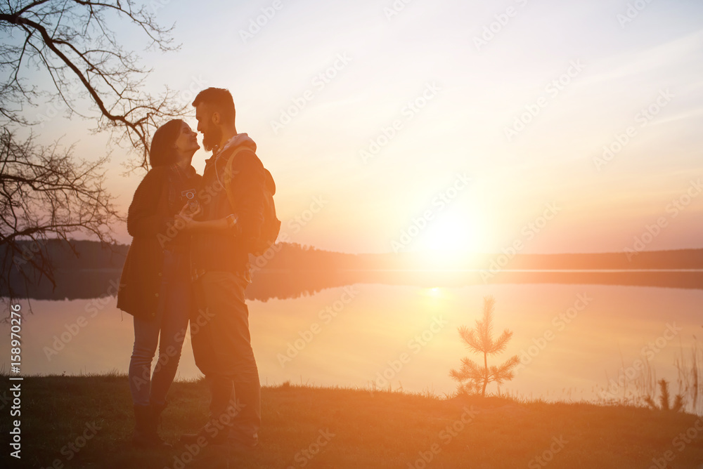 Young tourist couple at sunset sun