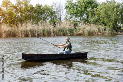 fisherman-man fishing on river.