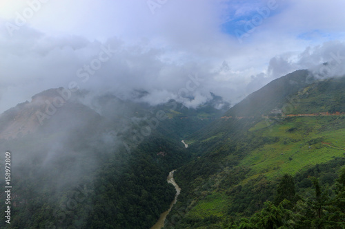 Scenery of foggy hills and Mangde River in Bumthang, Bhutan