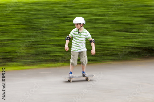 boy skating with speed with blurred background