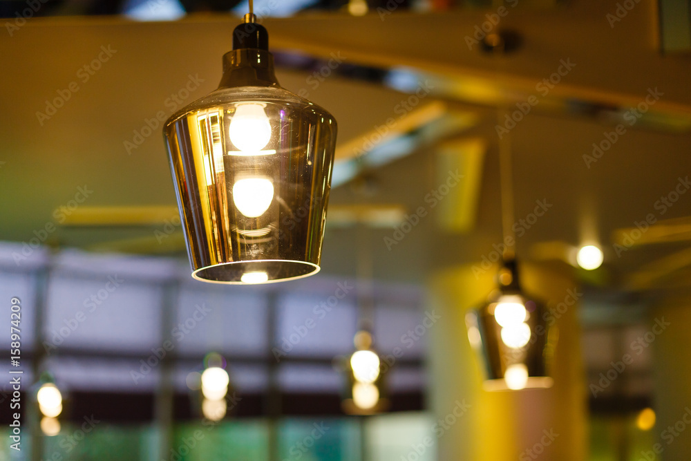 interior of restaurant with big lamps in golden light
