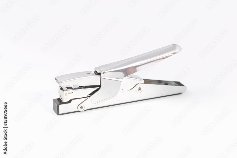 Female hands on a white background with a stapler. Female hands on a white background with a stapler.