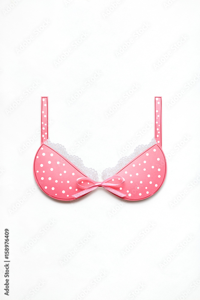 New bra / Creative concept photo of a bra with a bow made of paper on white background. New bra / Creative concept photo of a bra with a bow made of paper on white background.
