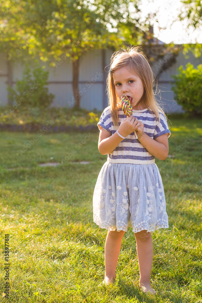 cute cauasian baby girl and big lollipop cute cauasian baby girl and big lollipop