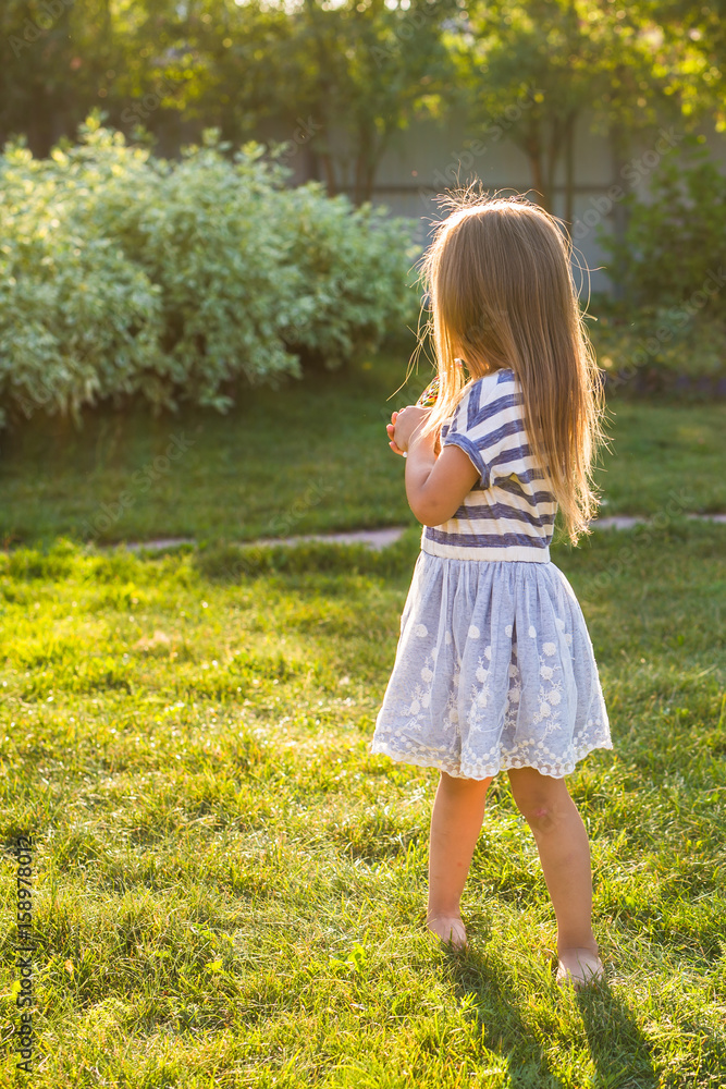 happy child girl playing on meadow in summer in nature happy child girl playing on meadow in summer in nature