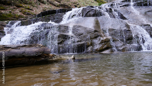 Beautiful river flowing over large rocks in a scenic natural landscape