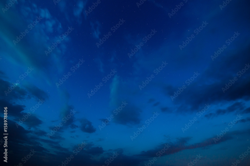 Starry sky with clouds. Summer twilight.