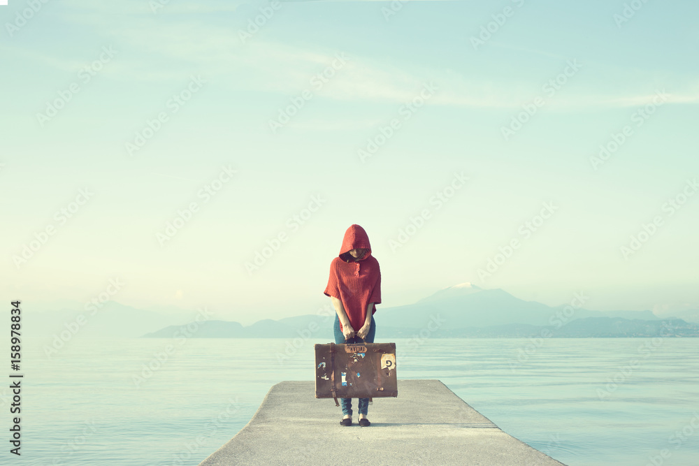 Mysterious woman in red hides her face under the hood in an enchanted ...