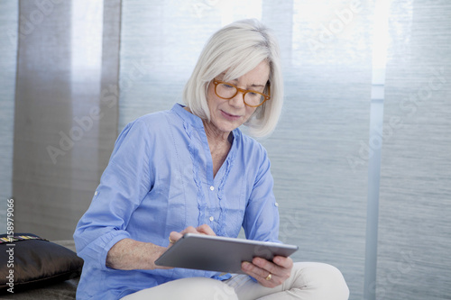 Senior woman using tablet computer