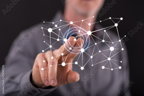 Man touching a virtual network concept on a touch screen