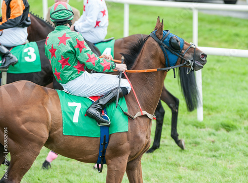 Race Horse riders galloping in the racing competition