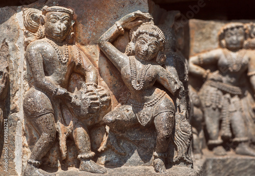Ruined dancing people on relief of the 12th century Hoysaleshwara temple in Halebidu, India.