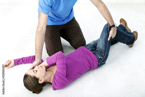 First aid techniques : placing the victim in the recovery position Step 3 : catch hold of the leg furthest away from you behind the knee, lift it up keeping the foot on the ground Turn the victim towards you